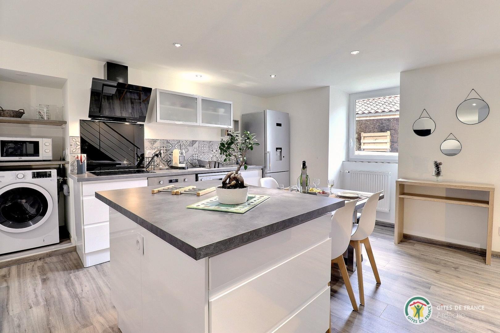 Cuisine équipée avec îlot central dans la pièce de vie