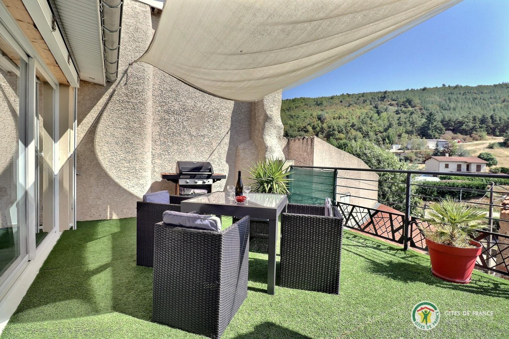 Terrasse avec salon de jardin.